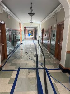 ater extraction in a school hallway after flooding to prevent structural damage and mold growth