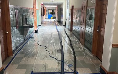 ater extraction in a school hallway after flooding to prevent structural damage and mold growth