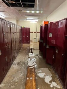 School locker room damaged by flooding, requiring restoration and renovation projects